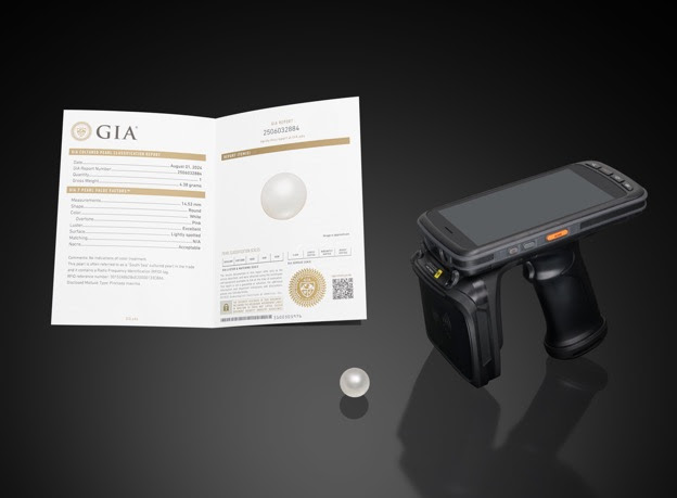 GIA_Cultured_Pearl_Reports.jpg:Pictured above, a South Sea cultured pearl containing an RFID tag, an RFID reader, and a GIA Cultured Pearl Classification Report describing the RFID reference number.
